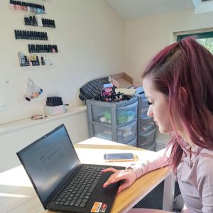 YP using laptop to complete her qualification